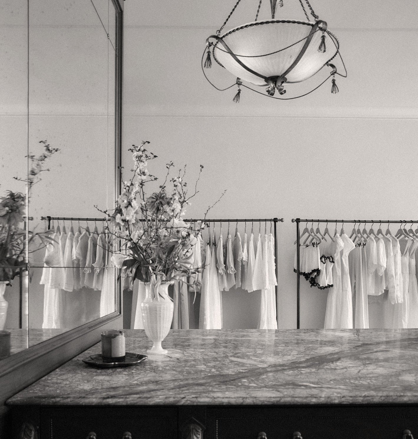 A considered clothing display with racks and decorative objects.